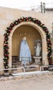 Decorated for the celebration of Christmas, the statue of Mary Magdalene near the Greek Catholic Church in Mi`ilya in Israel