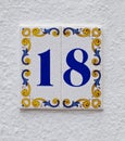 Ceramics house number on the wall eighteen Royalty Free Stock Photo