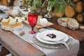 Decorated Christmas holiday table ready for dinner. Beautifully set with candles, spruce twigs, plates and serviettes Royalty Free Stock Photo