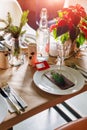 Decorated Christmas holiday table ready for dinner. Beautifully decorated table set with candles, spruce twigs, plates Royalty Free Stock Photo