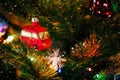 Decorated Christmas tree close up. Red Christmas toy car and illuminated garland. New Year atmosphere, winter holidays Royalty Free Stock Photo