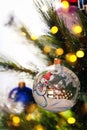 Decorated christmas tree closeup. Snowman ball and illuminated gold garland. New Year atmosphere. Winter holiday background. Royalty Free Stock Photo