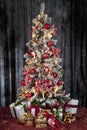 Decorated christmas tree with electric candles and presents Royalty Free Stock Photo