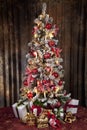 Decorated christmas tree with electric candles and presents Royalty Free Stock Photo