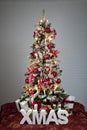 Decorated christmas tree with electric candles and presents Royalty Free Stock Photo