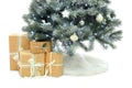 Decorated Christmas tree with faux fur skirt and gift boxes on background Royalty Free Stock Photo