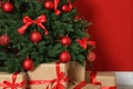 Decorated Christmas tree and gift boxes near wall Royalty Free Stock Photo