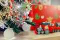Decorated Christmas tree lights twinkling and sparkling and Christmas wooden train toys with snowman and friends and gift box in Royalty Free Stock Photo