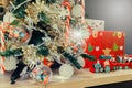 Decorated Christmas tree lights twinkling and sparkling and Christmas wooden train toys with snowman and friends and gift box in Royalty Free Stock Photo