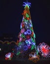 Decorated Christmas tree outside with lights covered with bright toys. Decorated streets and buildings Royalty Free Stock Photo