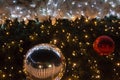 Decorated Christmas tree with shining lights, toys and white rib Royalty Free Stock Photo