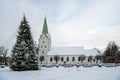 A decorated Christmas tree in a town square with a church in the background, Dobele, Latvia Royalty Free Stock Photo