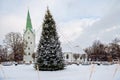 A decorated Christmas tree in a town square with a church in the background, Dobele, Latvia Royalty Free Stock Photo