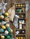 Decorated Christmas tree in yellow-green style in front of blurred background. Wooden background with old shelf with Christmas Royalty Free Stock Photo