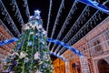 Decorated Christmas tunnel and Christmas tree in the night street of the city