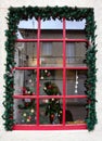 Decorated Christmas window with reflection of tourist in Delphi Greece Royalty Free Stock Photo