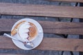 Decorated coffee with cookie and spoon on a wooden table. Close Royalty Free Stock Photo