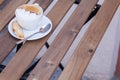 Decorated coffee with cookie and spoon on a wooden table. Close Royalty Free Stock Photo