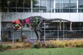Decorated dinosaur skeleton statue by plants outside google office building