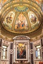 Decorated dome ceiling inside catholic church in Naples