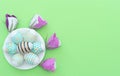 Decorated Easter egg lie on the white plate on green background with flowers made of paper. Happy Easter holiday concept. Greeting Royalty Free Stock Photo