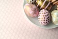 Decorated Easter eggs in a bowl, closeup on pastel background Royalty Free Stock Photo