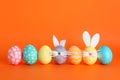 Decorated Easter eggs and cute bunny`s ears on background
