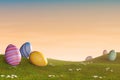 Decorated Easter eggs in a grassy hilly landscape at sunset