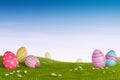 Decorated Easter eggs in a grassy hilly landscape