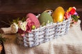 Decorated Easter eggs in a wicker basket, decor for photo shoots Royalty Free Stock Photo