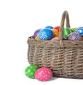 Decorated Easter eggs in wicker basket on white Royalty Free Stock Photo