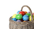 Decorated Easter eggs in wicker basket on white Royalty Free Stock Photo