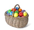 Decorated Easter eggs in wicker basket on white Royalty Free Stock Photo