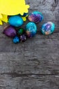 Decorated Easter eggs on wooden background, top view