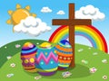 Decorated eggs and christian cross at easter meadow