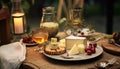 Decorated empty dining table with cheese plate, honey, glass of drink Royalty Free Stock Photo