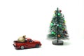 Decorated fake Christmas tree and a pickup with christmas ball on white background