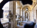 Statues seen from an iron grate window of Palace Mattei of Jupiter to Rome in Italy.