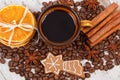 Decorated gingerbread, cup of coffee and grains, spices, christmas time Royalty Free Stock Photo
