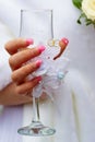 Decorated glass in the bride's hand