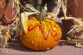 Decorated goosebump pumpkin with harvest decorations Royalty Free Stock Photo