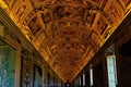 Decorated hallway in the Vatican with murals on the ceiling and paintings on the wall