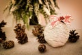 Decorated handmade Christmas bauble and pine cones on the table