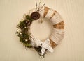 Decorated handmade Christmas wreath hanging on the wooden door