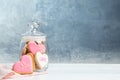 Decorated heart shaped cookies in glass jar on table. Royalty Free Stock Photo