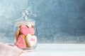 Decorated heart shaped cookies in glass jar on table Royalty Free Stock Photo