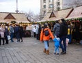 Decorated huge Christmas tree, lights, decorations, hot wine, hot chocolate, presents and people wandering at the Christmas market