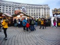 Decorated huge Christmas tree, lights, decorations, hot wine, hot chocolate, presents and people wandering at the Christmas market