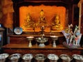 Decorated idols of Lord Buddha, Goddess Tara and Padmasambhava kept with bowls of offerings to Tibetan