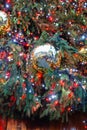 Decorated illuminated outside christmas tree showing reflection of Covent Garden, London, in a golden bauble Royalty Free Stock Photo